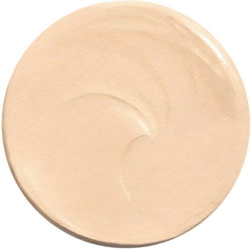 En rund beige skål med några kurviga linjer inuti, troligen för att hålla mat eller vätska.
