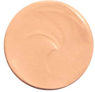 En cirkulær beige makeupprodukt med glat overflade og pumpekork, sandsynligvis foundation eller primer.