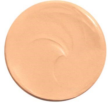Eine runde, beige Make-up-Grundierung mit glatter Oberfläche und leichten Krümmungsmustern.