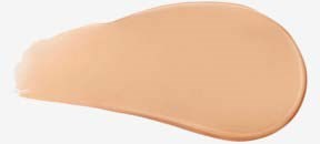En beige makeup-sponge med rund form och platt sida, används för att jämnt applicera foundation.