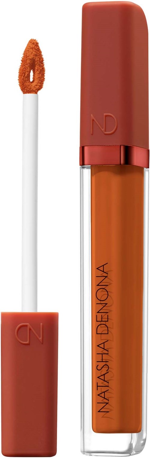 Läppglansrör med orange färg och en vit applicator. Text på röret säger Natasha Denona.