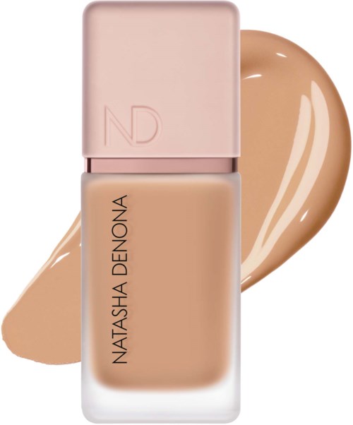 En nagellacksflaska med rosa lock och beige färgad lack, med ett färgprov i bakgrunden.