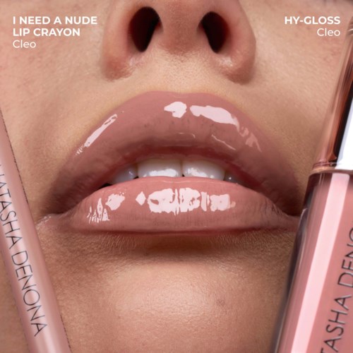 Close-up of glossy nude lipstick on lips with a Lip Gloss Cleo tube visible on side.