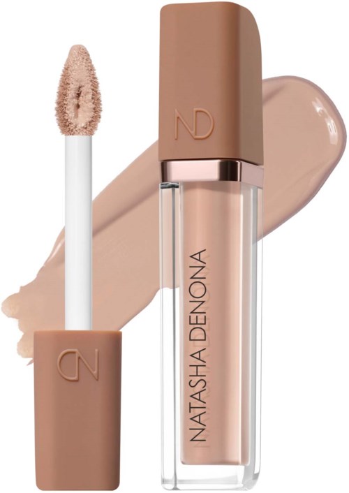 A lip gloss with a beige cap and applicator. The gloss is a light nude shade. The background shows swatches of the product.