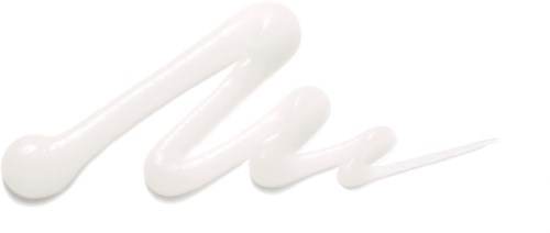 White cream is swirled on a black background, forming a squiggly line with a dollop at the start.