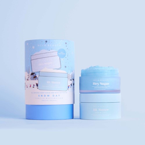 Three blue skincare jars, one with blue creamy product, on a light blue background.