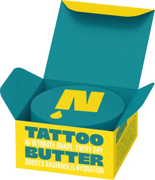 A teal and yellow box with an open lid revealing a container labeled Tattoo Butter that boosts radiance and hydration.