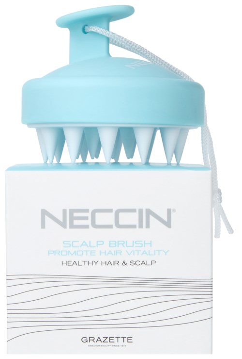 A blue scalp brush on top of white packaging with gray text, promoting healthy hair and scalp.