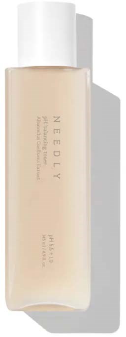 A beige skincare bottle with white cap, labeled 'NEEDLY' and some descriptive text, casting a shadow.