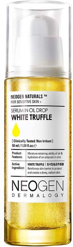 A yellow liquid serum bottle with a white pump and clear cap, labeled for sensitive skin and containing white truffle extract.