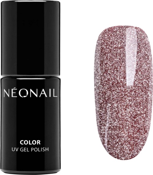 En flaske neon neglelak ved siden af en negl med pink glitter.