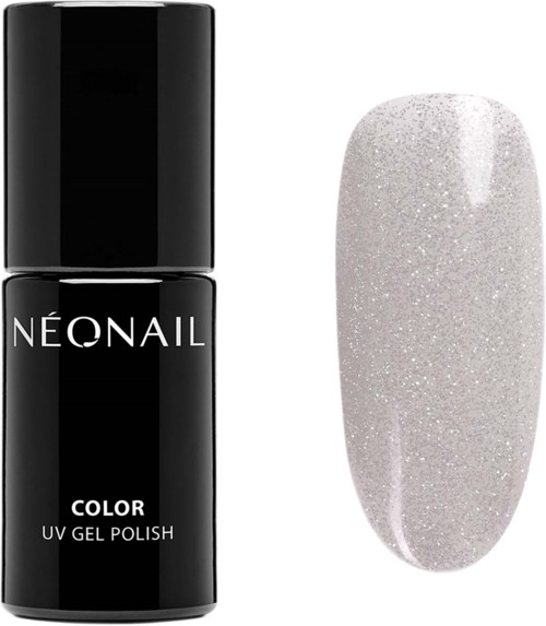 Black nail polish bottle next to a white glittery nail polish swatch.