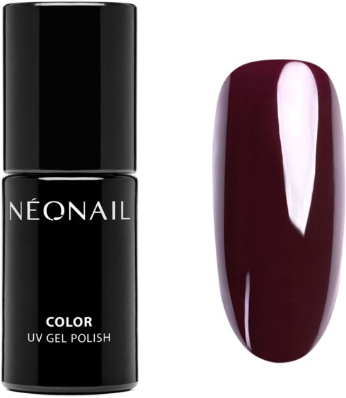 Black nail polish bottle next to a burgundy painted nail. Simple and elegant design. Focus on color and shape.