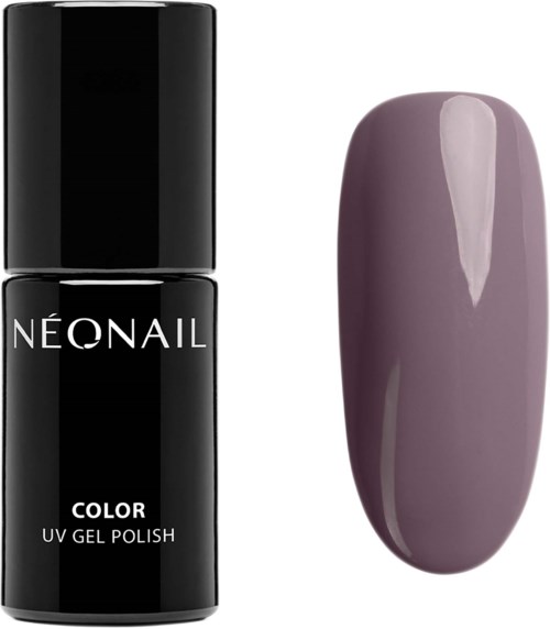 A black nail polish bottle with white text and a painted purple nail sample next to it.