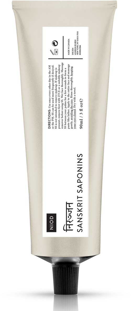 Een beige tube met een zwarte dop, met label 'Niod' en 'Patchouli Sanskrit Saponins', waarschijnlijk huidverzorgings- of cosmeticaproduct.