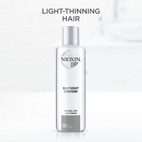 A white bottle of Nioxin scalp therapy conditioner for light-thinning hair, 300 ml, focusing on hair health.
