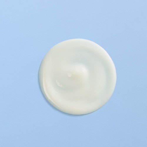 A white, smooth, round object on a light blue background.
