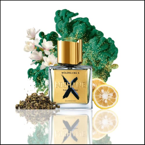 A perfume bottle with lotus flowers, green splash, lemon slices, and dried herbs or tea around it.