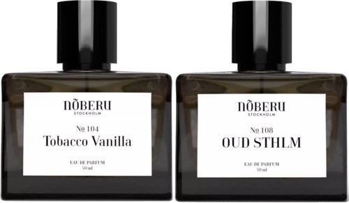 Två parfymflaskor med svarta lock och vita etiketter, som heter Tobacco Vanilla och Oud SLMH, 50 ml.