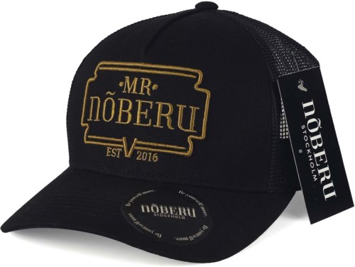 Musta trucker-hattu, jossa kultainen kirjailtu teksti ja logo, ja tarra sivulla.