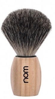 Scheerkwast met houten handvat en zwarte en witte haartjes, gemerkt 'nom'.