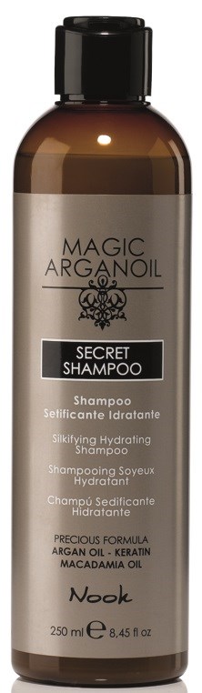 En brun flaska med Magic Arganoil Secret Shampoo med svart lock, etikett som visar ingredienser och varumärkesnamn Nook.