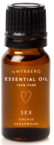 A small amber bottle with a black cap labeled 'Essential Oil' and 'Sex' with orchid and cedarwood scents.