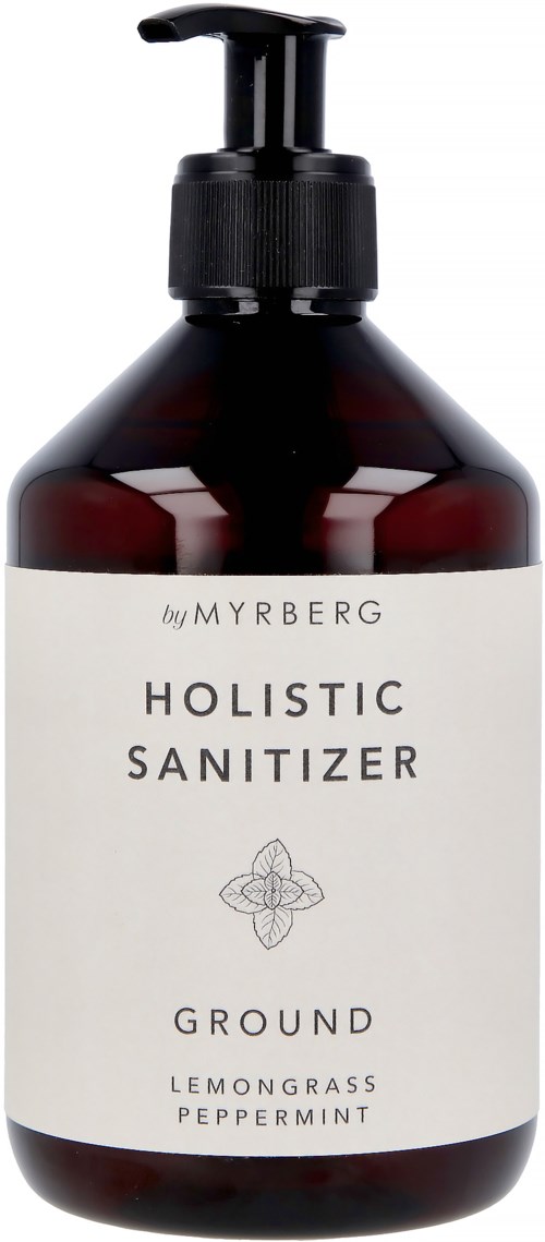 Een donkere fles met pomp, gelabeld 'Holistic Sanitizer' met citroen, gras en pepermuntgeuren.