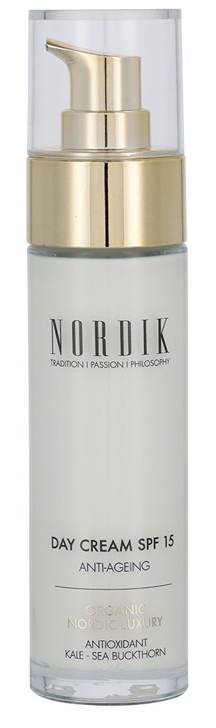A white bottle with a gold pump and clear cap, labeled 'Nordik Day Cream SPF 15' for skin care.