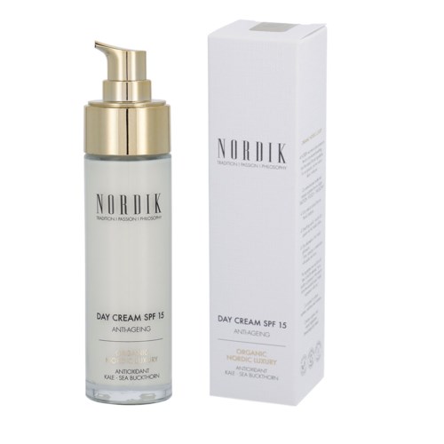 A bottle with a pump and a white box, both labeled 'Nordik Day Cream SPF 15' for skincare.