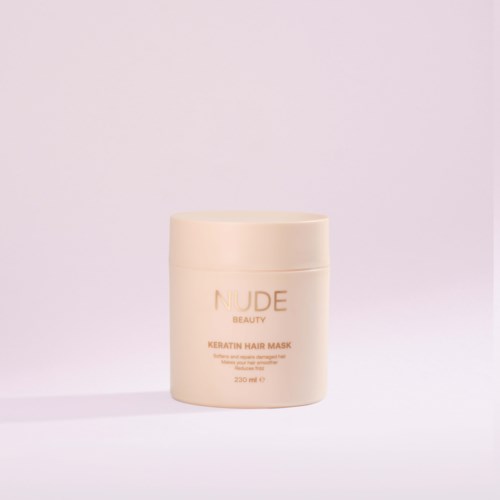 Een beige verpakking van Nude Beauty Keratin Hair Mask op een lichte achtergrond.