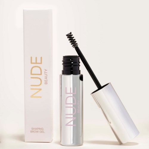 En bryngel i en silverrör med en svart borste, bredvid dess box märkt "Nuude Beauty".