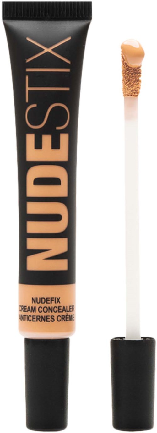 En concealer-enda i nudefärg med applikator, märkt 'NUDESTIX' och 'NUDEFIX' för att täcka hudimperfektioner.