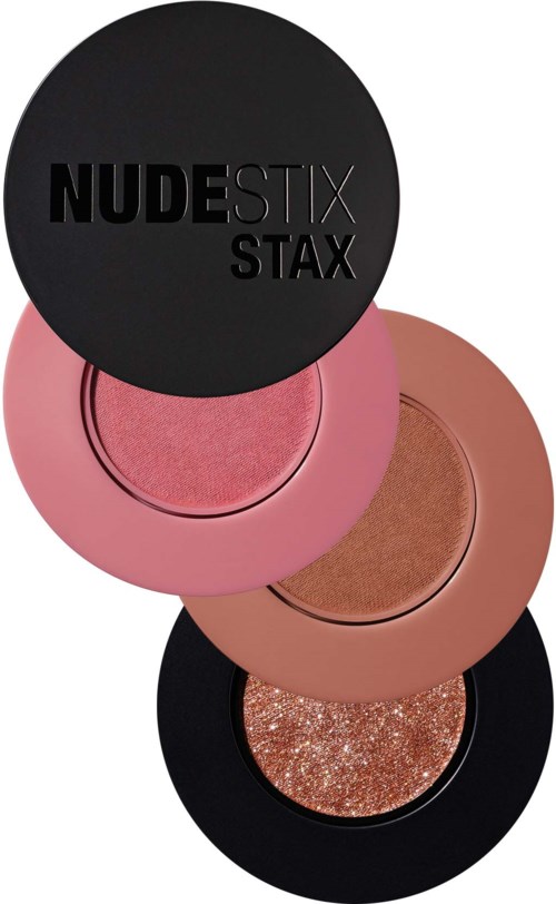 Vier runde Make-up-Behälter gestapelt, schwarz, rosa, beige und glitzernde Oberflächen.