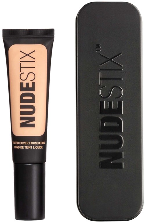 En tub med foundation och ett svart fodral med märket "NUDESTIX" på.