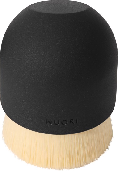 A black makeup brush with a rounded top and natural wood handle. The brand name 'NUORI' is visible on it.