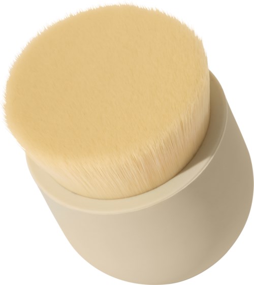 A round, soft brush with light-colored bristles and a white handle, used for cleaning or makeup.