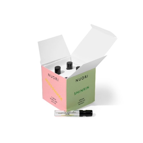 A box with four small bottles, labels say Nuori, one tube outside, suggesting skincare or perfume products.