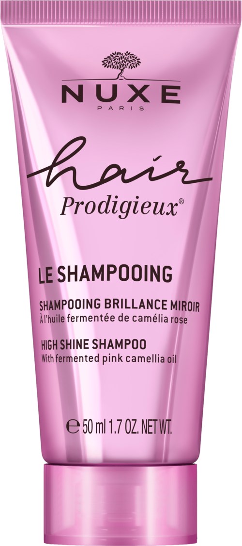 Pink tube of NUXE shampoo with black and white text, mentioning high shine and pink camellia oil.
