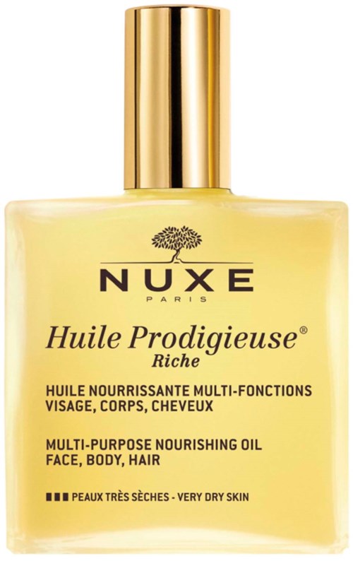 Eine gelbe Flasche mit goldener Kappe, gekennzeichnet mit NUXE Huile Prodigeuse, für Gesicht, Körper und Haare. Für sehr trockene Haut geeignet.
