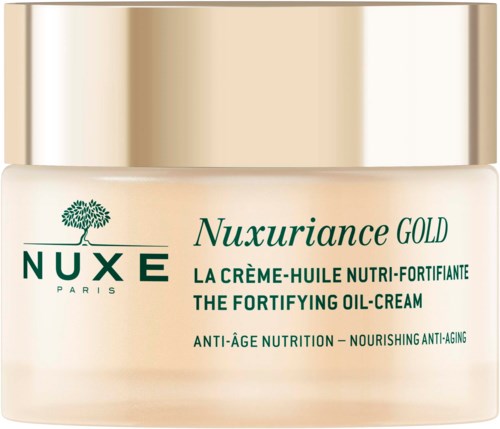 Et glass med Nuxe Nuxuriance Gold styrkende olje-krem for anti-aldring.