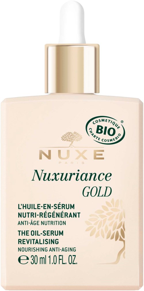 En beige flaska med droppkork, märkt Nuxe Nuxuriance Gold oljeserum med gröna och gyllene text och en trädillustration.