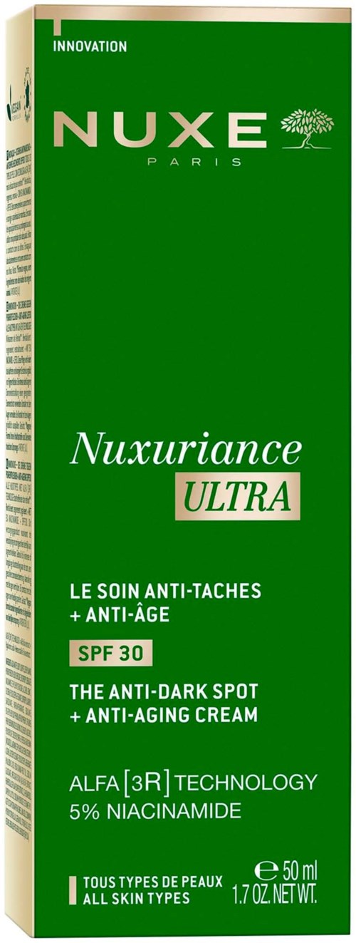 Grön förpackning med vit och grön text som marknadsför anti-mörka fläckar och anti-aging-kräm med SPF 30.