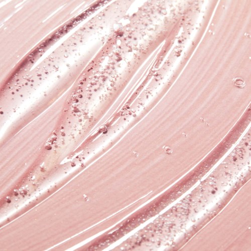 En närbild av en rosa, glansig yta med strimmor och små bubblor eller bumpar. Ser slät och blank ut.