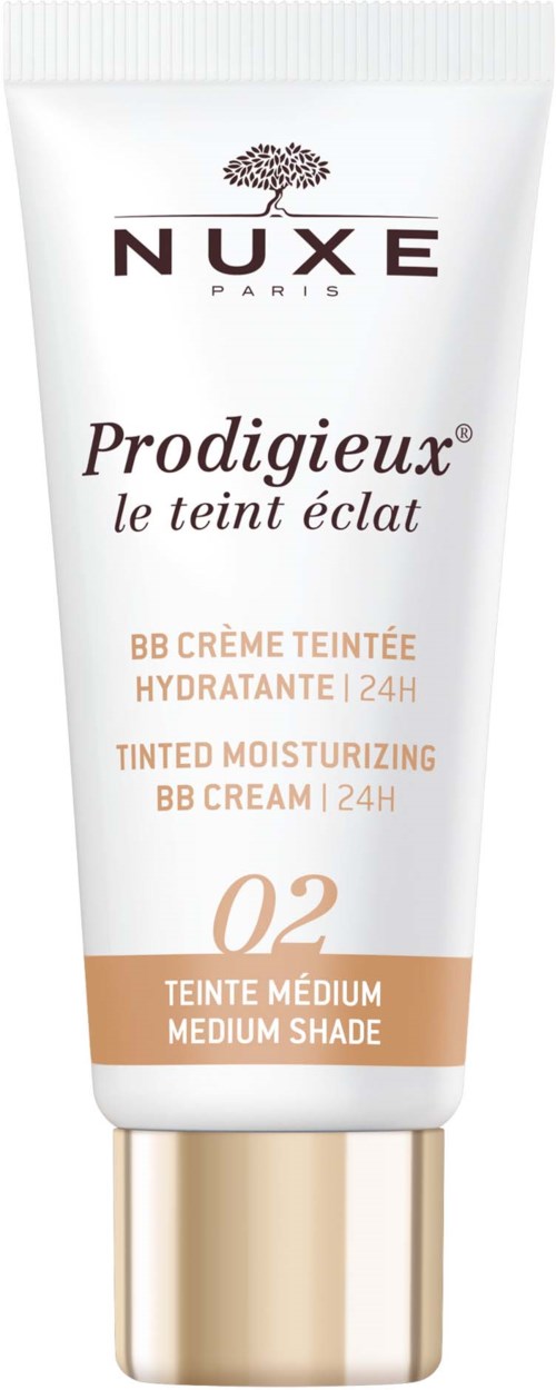 En hvid tube af Nuxe Prodigieux BB Cream til medium hudtone, med guldhoved og mærkelog, der giver 24 timers hydrering.