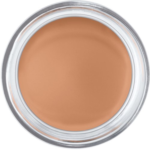 En rund förpackning fylld med beige makeup eller concealer i en burk.