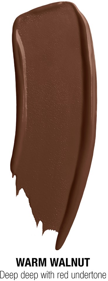 A smear of warm walnut-colored makeup or cosmetic product on a white background. Label says "WARM WALNUT".