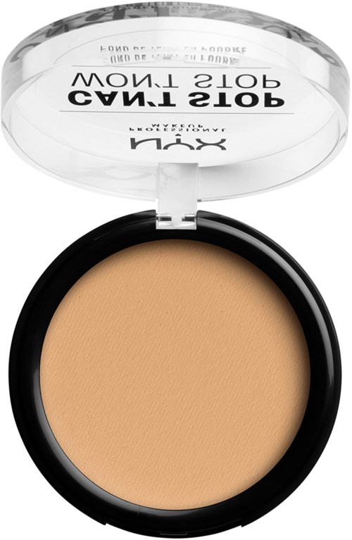 A round makeup compact with beige powder and a clear lid showing text inside.