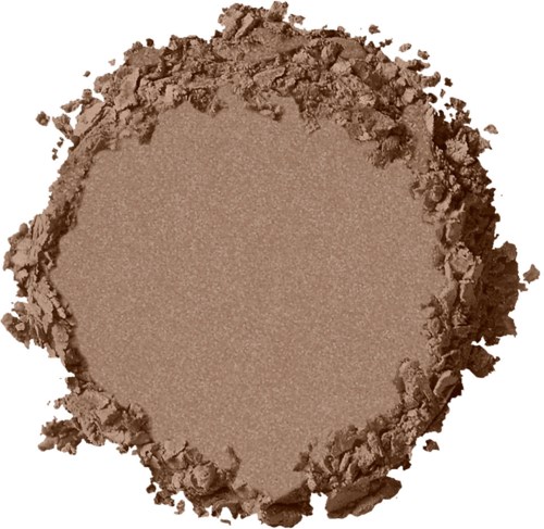 Ett runt område av pressat puder eller makeup med en ojämn, grynig kant och en slät mitt.
