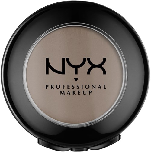 En rund svart behållare med tydligt lock som visar beige makeup inuti och NYX Professional Makeup-loggan på toppen.